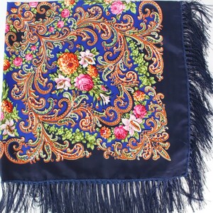 Pu&ograve; includere: Una sciarpa blu con motivo paisley e design floreale con frange.