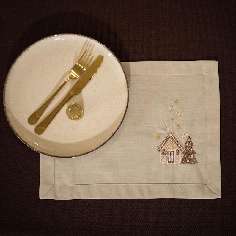 Christmas table napkin with embroidered gingerbread house design