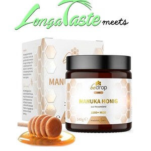 May include: A jar of Manuka honey with a black lid and a label that reads "Manuka Honig" and "1000+ MGO". A wooden honey dipper rests in a pool of honey. The words "Longa Taste meets" are written above the jar.