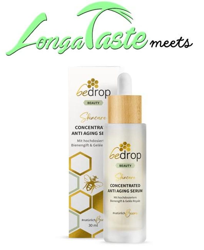 May include: A skincare product, "bedrop BEAUTY Skincare CONCENTRATED ANTI AGING SERUM", is displayed with a wooden cap and a dropper. The packaging includes text and a bee graphic. The text "Longa Taste meets" is above the product.