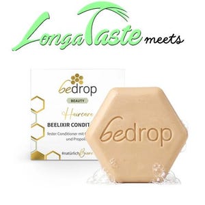 May include: A hexagonal, light brown solid conditioner bar with the word "Bedrop" embossed on it. The product is part of the "Haircare" line and is labeled "BEELIXIR CONDIT". The packaging includes the text "Longa Taste meets".