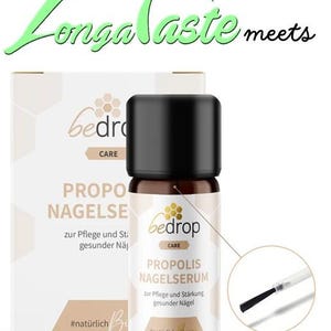 May include: A small brown bottle with a black cap and a white label. The label says "bedrop CARE PROPOLIS NAGELSERUM" and "zur Pflege und Stärkung gesunder Nägel". The bottle is sitting on a white box with a similar label.