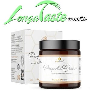 May include: A brown jar of Propolis Cream with a white label that says "bedrop Propolis Cream" and "enthält Bienenwachs und Traubenkernöl" in black text. The jar is sitting on a white box with a honeycomb pattern and the text "Propolis enthält Bienenwachs" in black text.