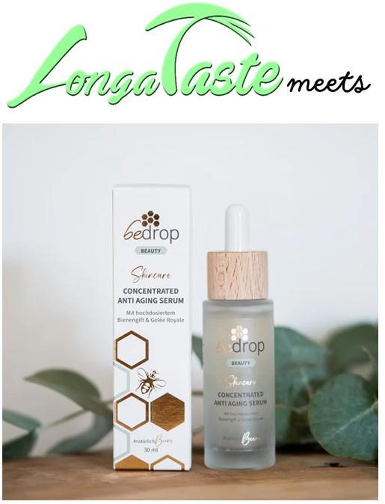 May include: A skincare product set featuring a bottle and a box. The box and bottle are labeled "bedrop BEAUTY Skincare CONCENTRATED ANTI AGING SERUM". The box has a honeycomb and bee design. The bottle has a wooden cap.