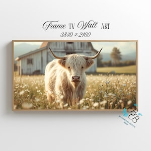 May include: A framed digital art print featuring a Highland cow in a field of wildflowers. The cow has long, shaggy, cream-colored fur and curved horns. The background includes a white barn and a soft, natural landscape. Text reads "Frame TV Wall ART 3840 x 2160".