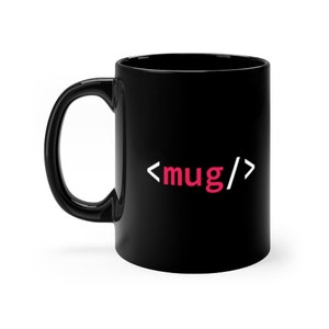 May include: A black ceramic mug featuring a white and pink graphic design on the front. The design displays the text <mug/>, with the angle brackets and forward slash in white and the word mug in a vibrant pink colour, centred on the mug surface.