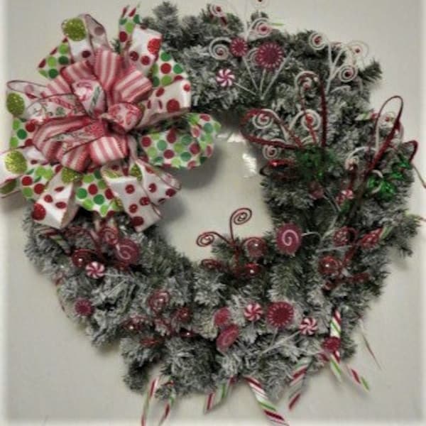 Xmas evergreen wreath oversize polka dot bow with candy and curled sprig accents