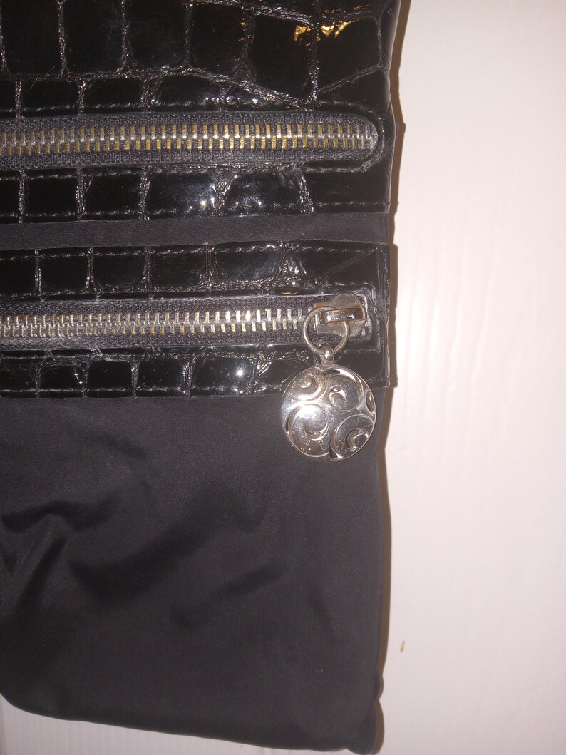 May include: A white ceramic mug with a black handle and the text "But First, Coffee" in a black, handwritten-style font. The mug is on a white surface. The mug is approximately 4 inches tall.