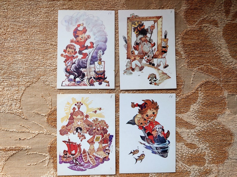 May include: Four vintage postcards featuring colorful illustrations of children in various scenes. The postcards are white with a light blue border and feature a number in the top right corner.