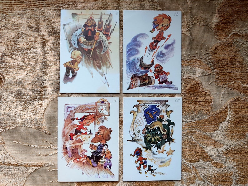 May include: Four vintage illustrated postcards featuring whimsical characters. The first postcard shows a man with a beard and a crown, the second shows a girl flying through the air, the third shows two people working on a clock, and the fourth shows a green creature with a crown.