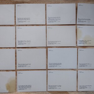 May include: A collection of 16 blank white postcards with text on the back. The text includes the name "Samara" and a series of numbers.
