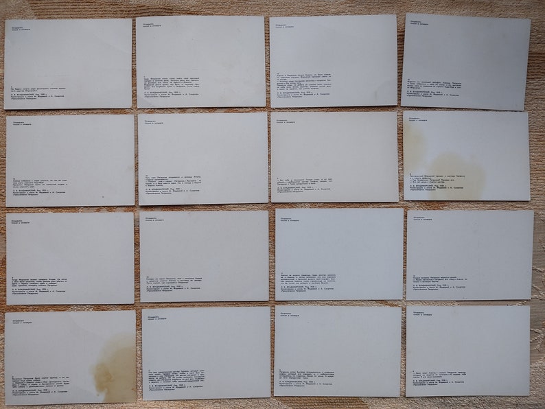 May include: A collection of 16 blank white postcards with text on the back. The text includes the name "Samara" and a series of numbers.
