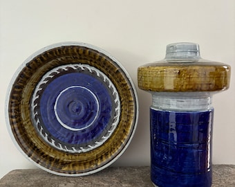 May include: A set of vintage ceramic pottery in blue, brown and white with a geometric pattern. The set includes a bowl and a vase.