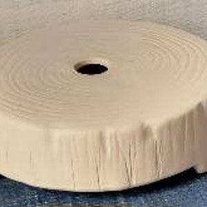May include: A ceramic pedestal with a tree trunk design, featuring a circular top with a hole in the center and a textured base with three legs.
