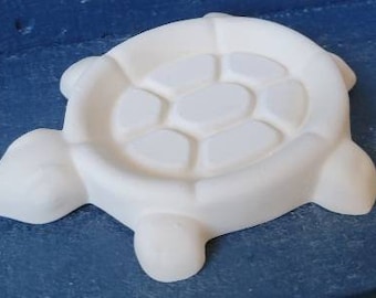Ceramic bisque ready to paint turtle  hand made dish or scrubby. Set a small potted succulent on it. 2" x 2.5" pot would fit the oval shape.