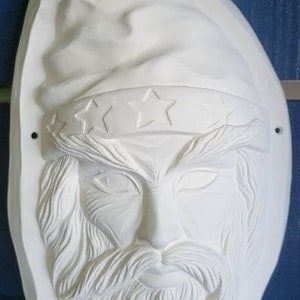Ceramic bisque magical wizard mask plaque or wall hanging. Has side holes for hanging