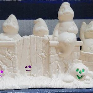 Ceramic bisque ready to paint Halloween scene. Unpainted bisque ghosts and pumpkins unpainted.