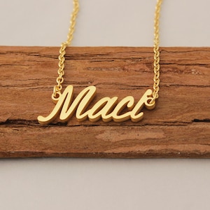 May include: Gold necklace with the name "Mack" written in a cursive font.
