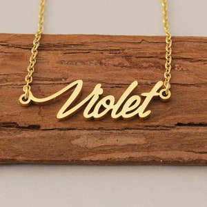 May include: A gold necklace with the name "Violet" written in a cursive script.