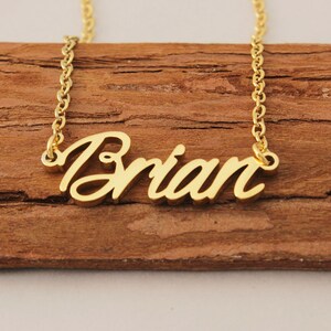 May include: Gold necklace with the name "Brian" spelled out in cursive.