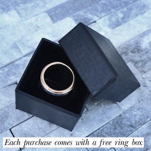 May include: A black ring box with a silver ring inside. Each purchase comes with a free ring box.