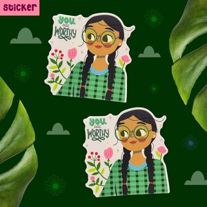 Peut inclure: Deux autocollants avec une illustration de dessin anim&eacute; d'une personne aux longs cheveux noirs portant une chemise &agrave; carreaux vert et blanc. Le texte sur l'autocollant est "You are worthy".