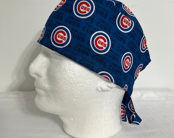 May include: Blue and white surgical scrub hat with a repeating pattern of the Chicago Cubs logo and the words "Chicago Cubs".