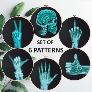 May include: A set of six embroidery patterns, each within a hoop, showcasing x-ray style hand gestures and a skull. The designs are teal on a black backdrop. The text "SET OF 6 PATTERNS" is also included.