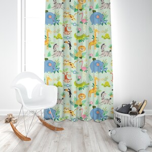 May include: A green curtain with a repeating pattern of jungle animals, including a giraffe, zebra, elephant, monkey, toucan, lion, and crocodile. The animals are all cartoon-like and colorful.