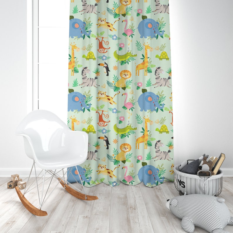 May include: A green curtain with a repeating pattern of jungle animals, including a giraffe, zebra, elephant, monkey, toucan, lion, and crocodile. The animals are all cartoon-like and colorful.