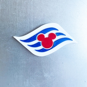May include: A white, blue, and red emblem featuring a stylized wave design with a red Mickey Mouse head in the center. The emblem is likely a logo or decorative element, possibly for a cruise line or related theme.