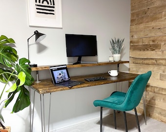 May include: A wooden desk with a metal frame and hairpin legs. The desk has two shelves and a green velvet chair. A laptop, keyboard, and a lamp are on the desk.
