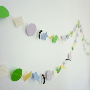 May include: A set of three ceramic mugs with a speckled, matte finish. The mugs are in shades of cream, light gray, and dark gray. Each mug has a simple, minimalist design, perfect for coffee or tea.