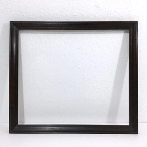 May include: A rectangular, dark brown wooden picture frame. The frame has a simple, classic design with a slightly beveled edge. The frame is empty, with a white background visible inside.