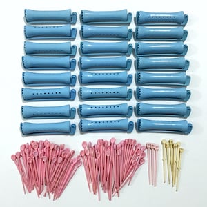 May include: A collection of vintage hair styling tools, including light blue plastic rollers and pink and cream-colored hair pins. The rollers are cylindrical with a ridged design and small holes. The pins are thin and pointed.