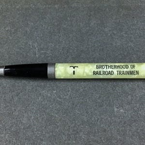May include: A yellow and black mechanical pencil with the text "Brotherhood of Railroad Trainmen" printed on the side.