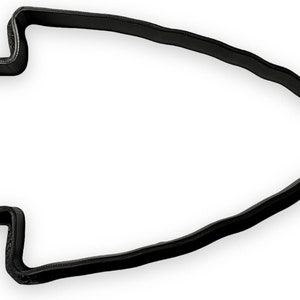May include: Black plastic cookie cutter shaped like an arrowhead.