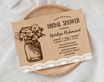 May include: A rustic brown paper bridal shower invitation with white lace trim. The invitation features a hand-drawn illustration of a mason jar filled with wildflowers. The text reads "Please join us for a Bridal Shower honoring Katelyn Richmond Sunday | 28 | August 20XX The Location Name 108 Celebration Street Hosted by Andrea RSVP to Kate by June 20 123.456.7890"
