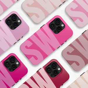 May include: A set of pink and light pink iPhone cases with a graphic design of the word "SWIM" in a bold, stylized font.