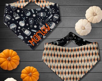 May include: Two Halloween-themed dog bandanas. One is black with white potion bottle illustrations and the name "Marley" in orange. The other is black with a diamond pattern in orange and cream. Decorative pumpkins and gourds are also present.
