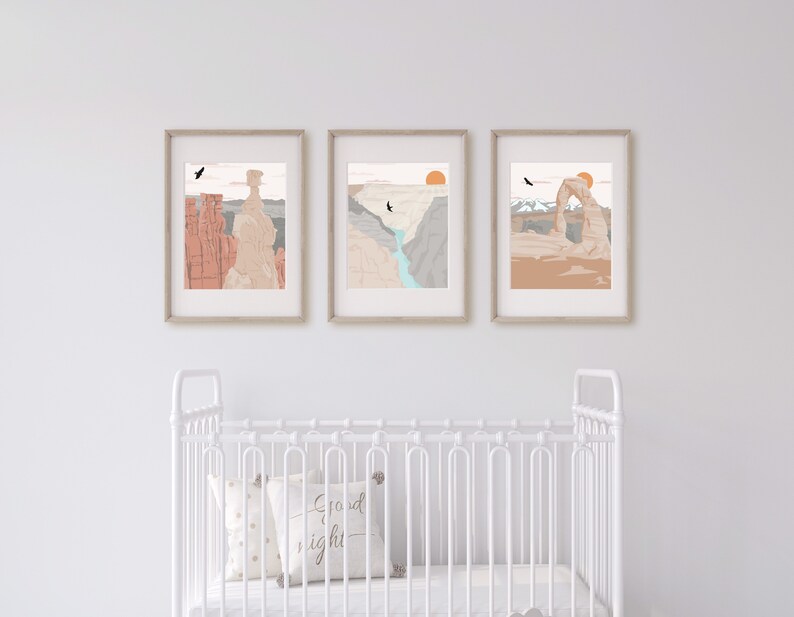 May include: Three framed prints of desert landscapes with a sunset, a canyon, and a natural arch. The prints are in a white room with a white crib in the foreground.