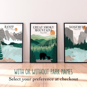 May include: Three framed prints of national parks with a minimalist design. The prints feature a mountain range, a forest, and a waterfall. The prints are labeled "Banff National Park", "Great Smoky Mountains National Park", and "Yosemite National Park".