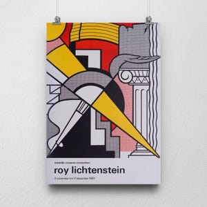 May include: A poster featuring a Roy Lichtenstein artwork with bold geometric shapes in yellow, red, black, and white. The poster includes the text "stedelijk museum amsterdam" and "roy lichtenstein" with the dates "3 november t/m 17 december 1967".