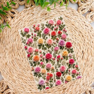 May include: A rectangular sheet of stickers featuring a dense pattern of small, vibrant roses in shades of pink, red, orange, yellow, and purple, interspersed with green leaves and delicate stems on a light, textured off-white background.