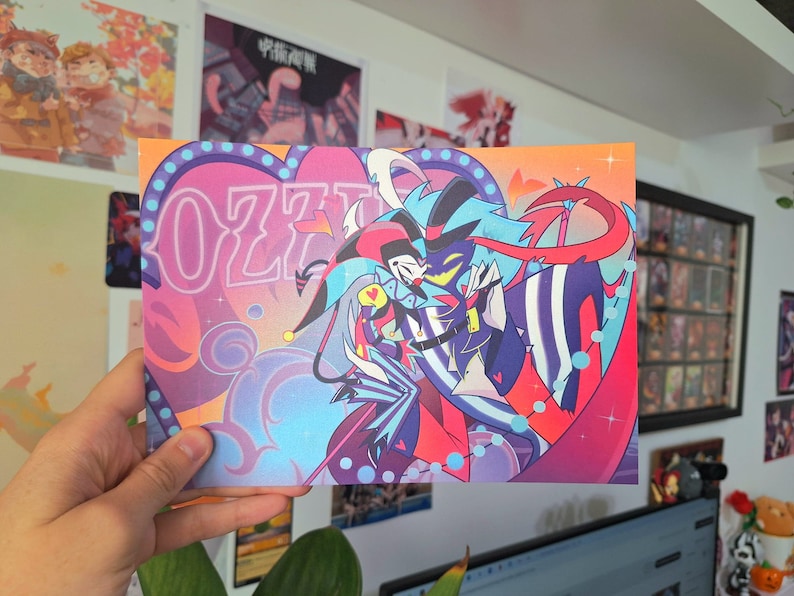 May include: A colorful illustration of two cartoon characters, one with blue hair and a red and black striped suit, and the other with a red and black jester hat and a blue and white suit. The characters are embracing and the background is a pink and blue heart with the word "OZZY" in neon pink letters.