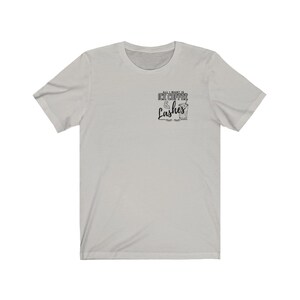 May include: A light grey t-shirt with the text "All I want is Ice Coffee & Lashes" printed on the front. The text is in black and features a stylised image of a glass of iced coffee.