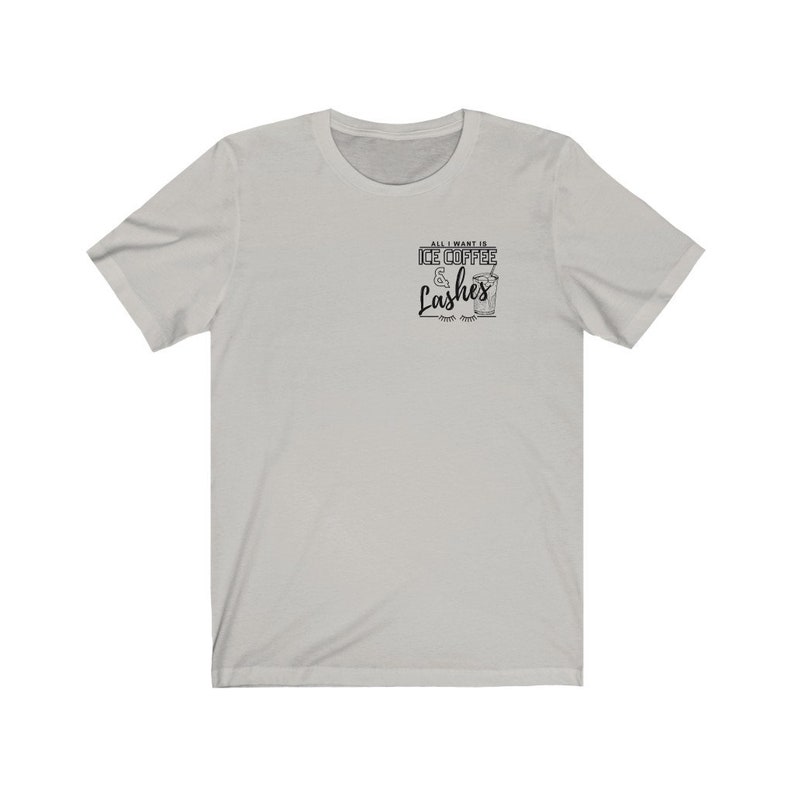 May include: A light grey t-shirt with the text "All I want is Ice Coffee & Lashes" printed on the front. The text is in black and features a stylised image of a glass of iced coffee.