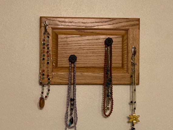 Necklace Hooks on Repurposed Oak Cabinet Door 