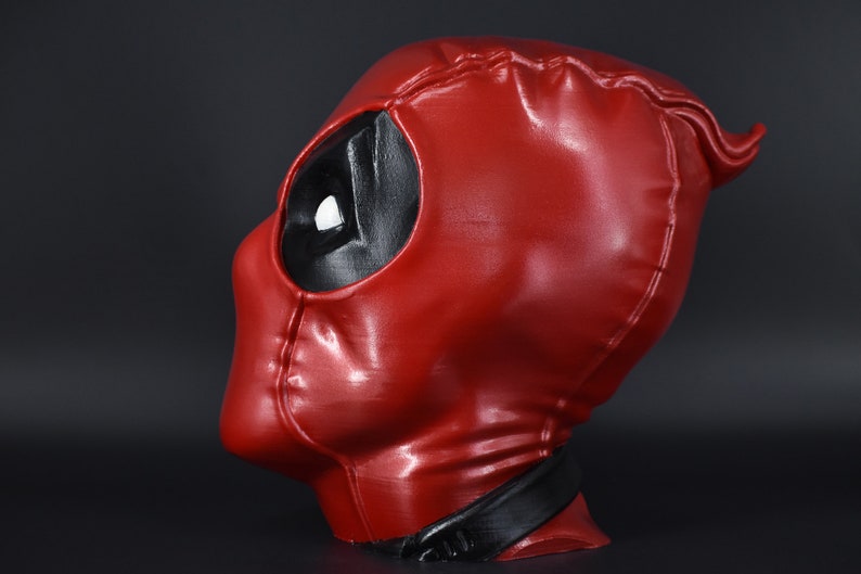 May include: A red and black Deadpool mask with a glossy finish. The mask is made of a durable material and features a detailed design.