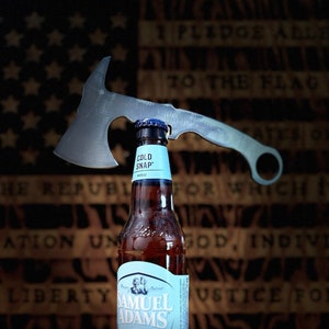 May include: A bottle of Samuel Adams Cold Snap White Ale with a blue label and a hatchet-shaped bottle opener.